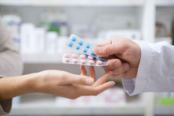 mature-pharmacist-helping-his-female-customer
